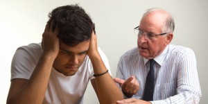 Concerned young man gets advice from senior man